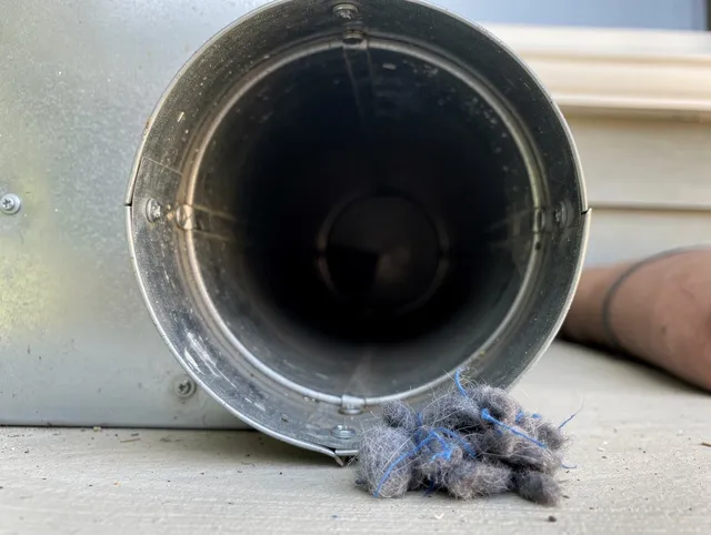 Bonita Springs Dryer Vent Cleaning technician using specialized equipment to clear severe dryer vent blockage in Bonita Springs